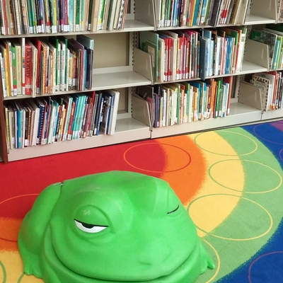 Children's books and frog chair